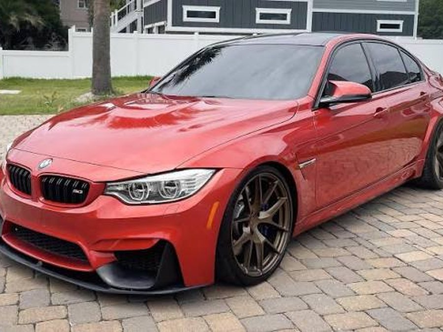 Red performance sedan exterior demo photo